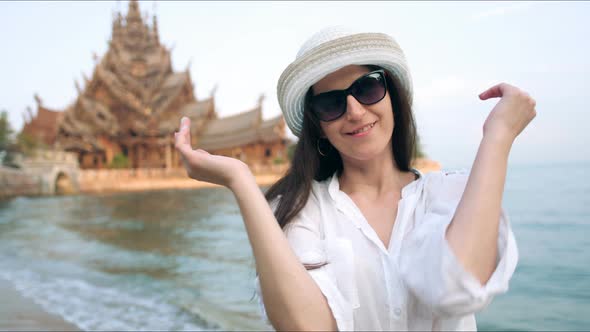 Young Woman Touirist Smiling and Posing in Front of the Ancient Temple