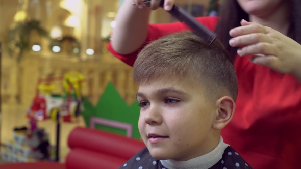 Female Haircutting Baby in Beauty Salon