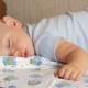 Beautiful Baby Sleeping in Funny Pose on a Bed. Under the Baby Diaper, the Boy About a Year - VideoHive Item for Sale