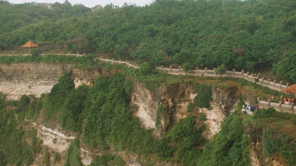 Long Tourist Road Is Located Along the Cliffs Above the Ocean. A Large Number of People Walking