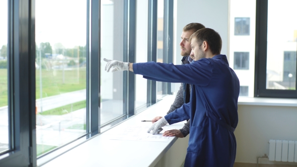 Cheerful Young Foreman Is Showing To the Architect the Problems of Construction