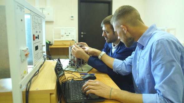 Young Engineers Working in the Laboratory and Using a Computer