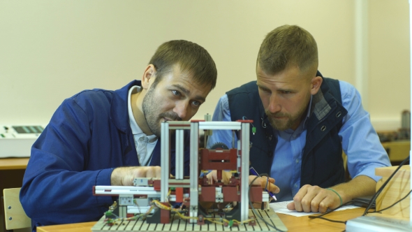 Two Young Engineers Working on a Project Together in Science Lab