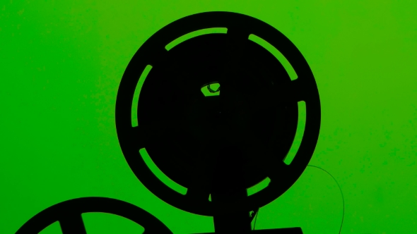 Cassette Projector Film Rotates in Frame. Studio Green Screen alt