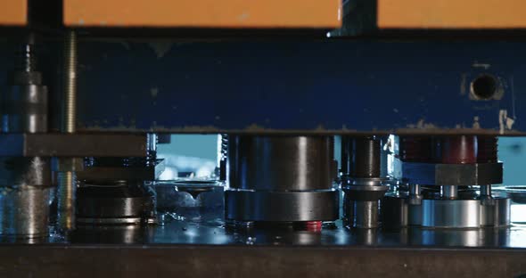 Close up shot of a punch press forming metal parts