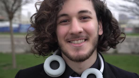 Portrait of a Happy Young Man with Curly Hair