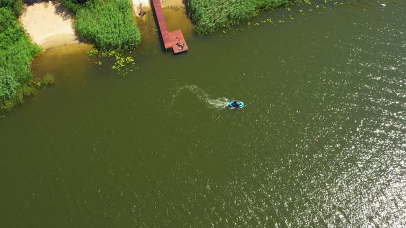 Luxury boat in dark color, fast movement on blue water, aerial view. Expensive luxury Italian boat m