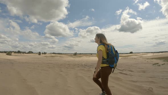 Young Female Hiker Walking in Dunes. Slow Motion