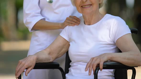 Attentive Doctor Stroking Shoulder of Disabled Patient Professional Medical Care