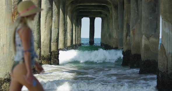 Waves splashing and crashing under pier