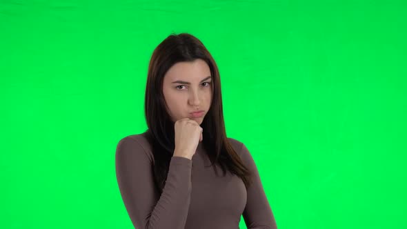 Attractive Girl Stands Offended and Then Smiles. Green Screen