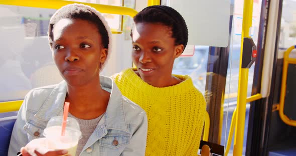 Twin sisters sitting together in the bus 4k