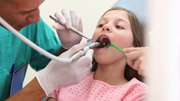 Girl having her teeth fixed at the dentist's