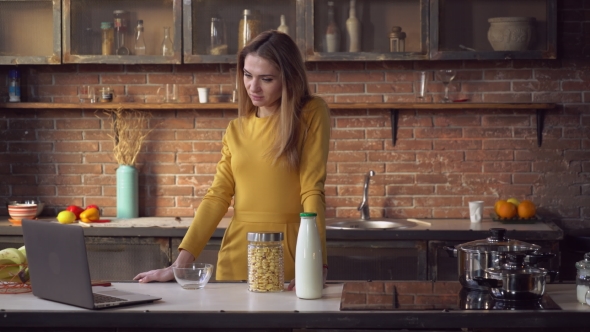 Businesswoman Working with Pc and Eating in Flat