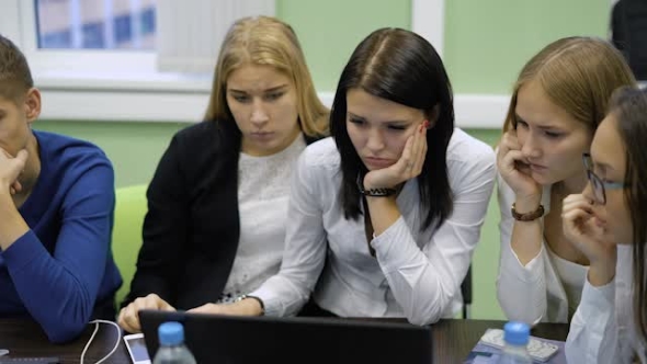 University Students Preparing for the Exam. Students on Their Laptops Browsing Lectures, Pass