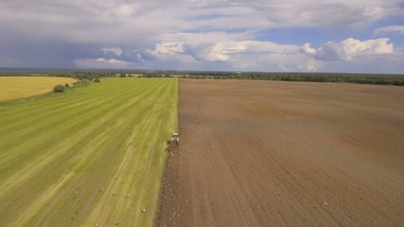 Tractor Plowing a field.Aerial Video.