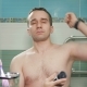 A Young Attractive Man Gets Antiperspirant Spray in the Bathroom of the Hotel Room - VideoHive Item for Sale