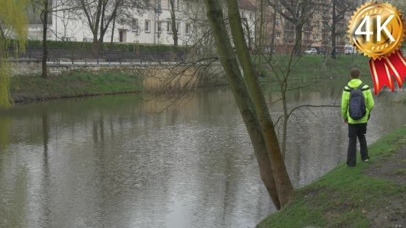 An Adult Man Approaches to a River