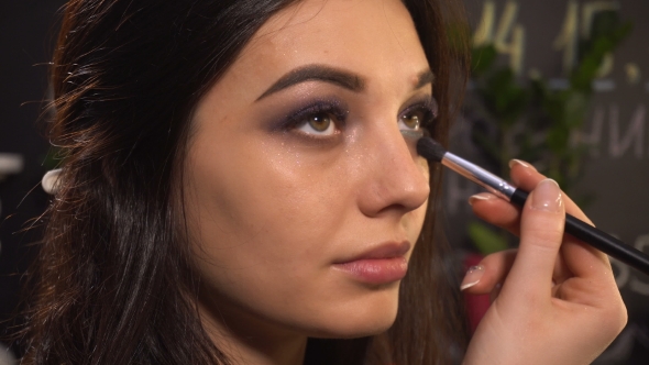 Makeup Artist Makes Makeup for Woman Model