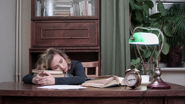 Tired Female Taking a Nap on Pile of Books at Her Workplace and Being Woken Up By an Alarm