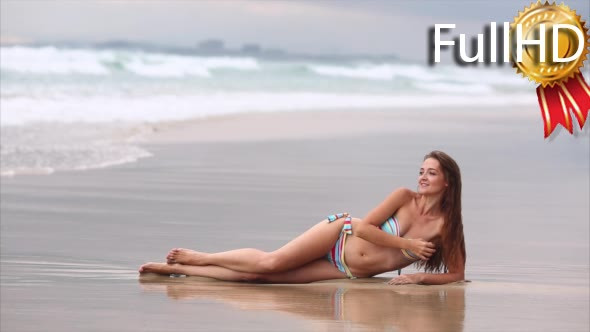 Young Woman in Colorful Swimsuit Lying on the