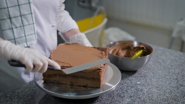The Woman at a Leisure in Kitchen Cooks Chocolate Cake
