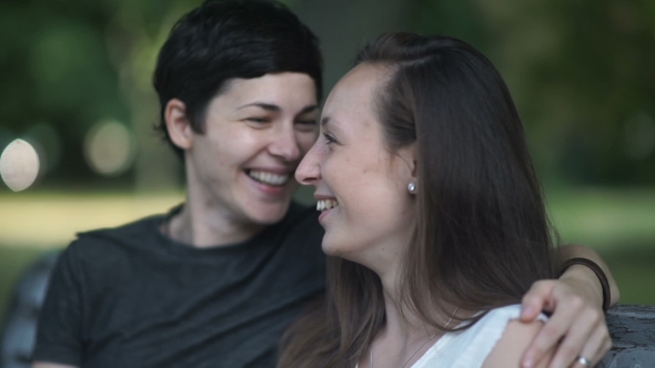 Two Lesbians Kisses on Bench in Park