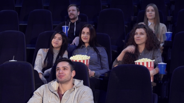 Young People Watch Film at the Movie Theater