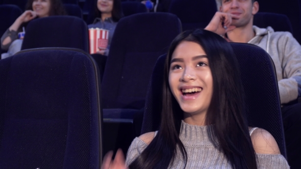 Woman Watches Comedy at the Movie Theater