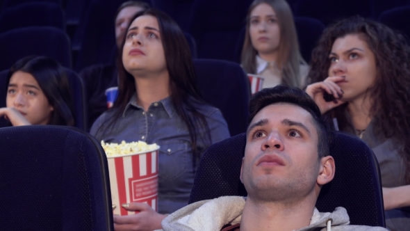 People Watch Serious Film at the Movie Theater