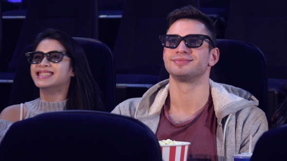 Guy Sit Between Two Girls at the Movie Theater