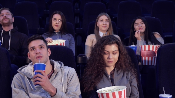 Man Takes His Place at the Movie Theater