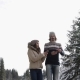 Couple Winter Snow Forest Road Walking Man And Woman Messaging Online Cell Smart Phone In Snowy Park - VideoHive Item for Sale