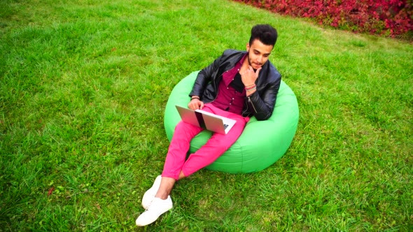 Handsome Arab Young Businessman Sits With Laptop