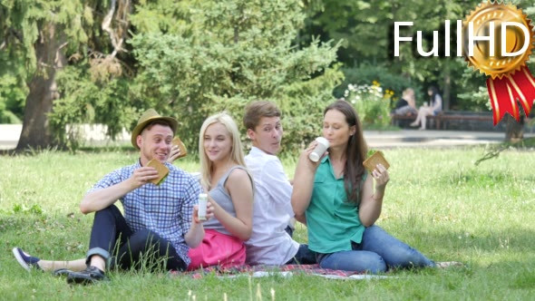 Young People Have Food and Drink on a Lawn Summer