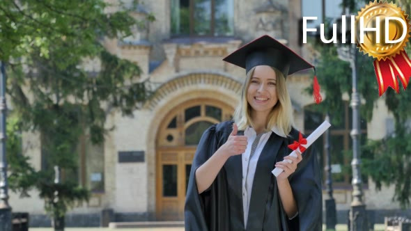 Graduand Woman in Mantle Shows Her Thumb Holding