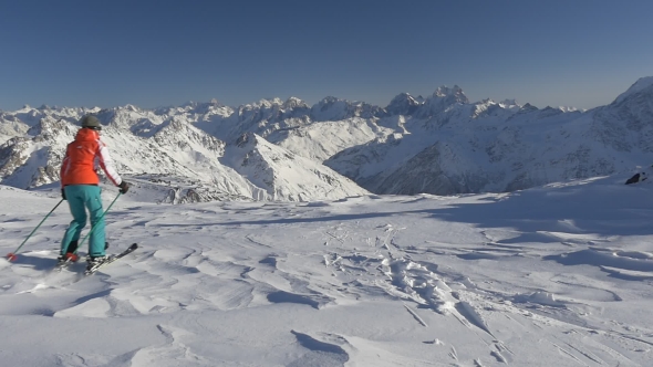 Sporty Woman Skiing on Beautiful Ski Resort