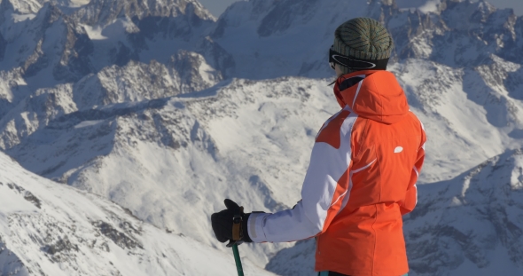 Woman on Ski Resort Looking at Mountains