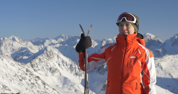 Woman with Skis Enjoys Beautiful View