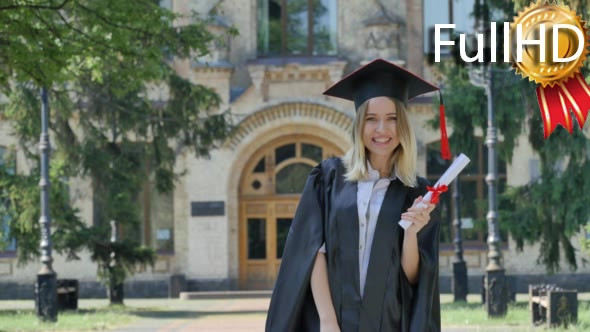 Graduand in Mantle Raises Her Fists Shows Diploma