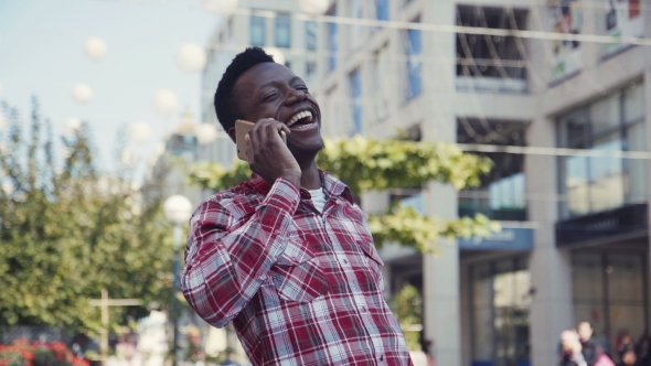 Afro American Man Talking By Smartphone.