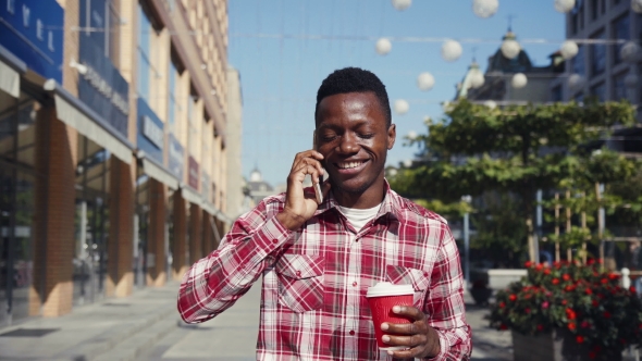 Cheerful Guy Talking on His Cell Phone