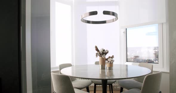 Minimalist Modern White Dining Room with White Chairs and Minimalist Lamp