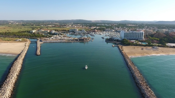 Flying Above the Entrance To the Port, with a Yacht Marina.