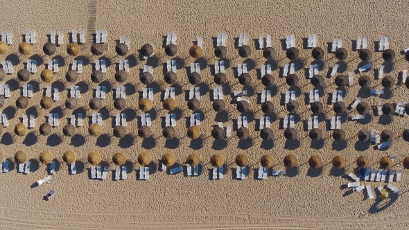 Filming Ascent on Sunbeds on the Beach in Summer