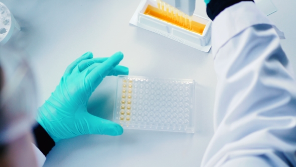 Researcher Dispenses a Liquid in a Test-Tubes