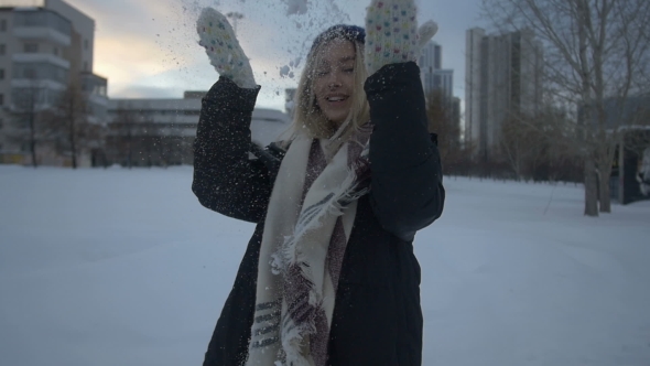 Beautiful Girl Playing with Snow and Fun