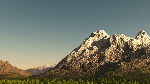 Green Valley and Mountains in Snow at Sunset alt