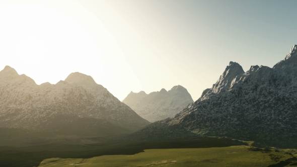 Green Valley and Mountains in Snow at Sunset alt