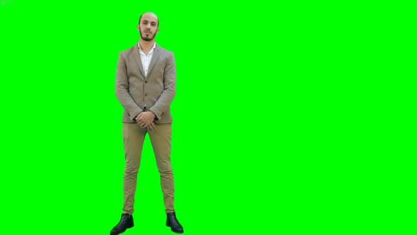 Businessman Presenting Project To the Camera on a Green Screen, Chroma Key.